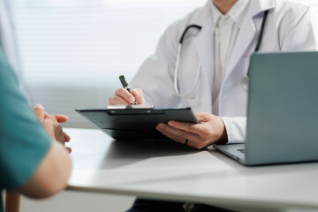 Patient consulting doctor about chronic back pain.
