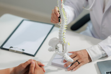 Patient consulting doctor about chronic back pain.