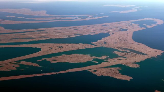 4k aerial video footage, flying along landscape of Flaherty Island, the largest island of Belcher Islands group in Hudson Bay, Qikiqtaaluk Region, Nunavut, Canada with Inuit community of Sanikiluaq