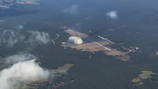 4k aerial video footage, flying along Tropical Islands Resort, a tropical-themed indoor water park in an airship hangar at former Brand-Briesen Airfield. The hall belonged to company "Cargolifter" 