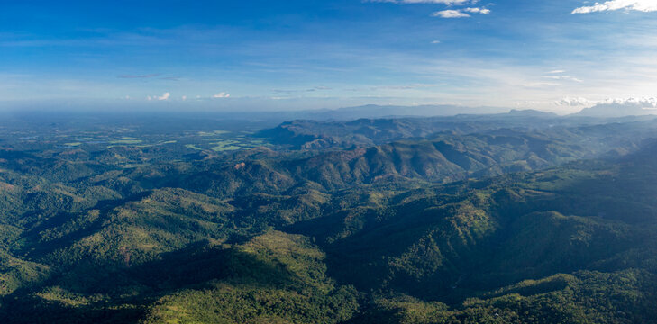 A stunning aerial view from Haputale, Sri Lanka, showcases lush green mountains, valleys, and dramatic clouds stretching towards the southern province.