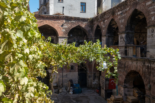 Historic Ottoman caravanserai inn courtyard with stone arches and workshops in Istanbul Turkey showing traditional architecture and cultural heritage site