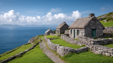 Scenic Coastal Landscape with Traditional Stone Cottages and Lush Green Fields Overlooking the Ocean Under a Blue Sky with Fluffy Clouds