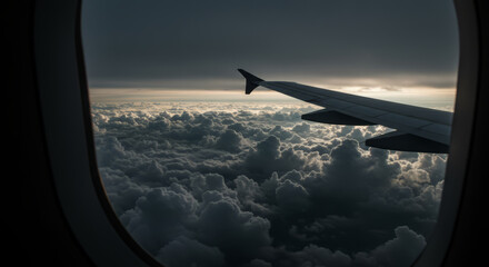 Airplane Wing Above Dramatic Cloudscape at Sunset.