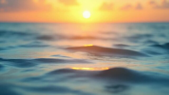Abstract aerial sea summer ocean sunset nature background. Small waves on water surface in motion blur with golden bokeh lights from sun. Holiday, vacation and recreational concept. Slow motion