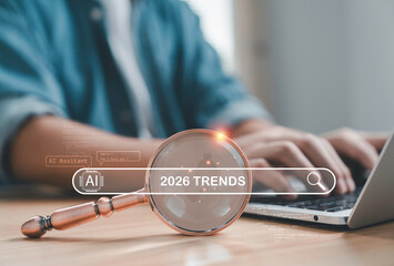 Businessman searching 2026 trends with magnifying glass and AI assistant interface symbolizing future technology digital innovation  business forecast and global market insights.