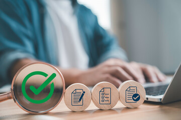 Businessman using laptop with checklist icons and green check mark symbolizing approval completed task quality assurance project management document verification and successful business process.