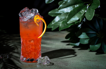 Rose lady, low alcoholic cocktail drink with cider, cranberry and orange juice. Deep green...