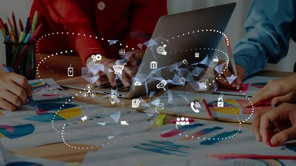 A vibrant scene of teamwork where individuals collaborate at a table filled with paperwork and a laptop, enhanced by digital icons illustrating technology and innovation. Raster - Powered by Adobe
