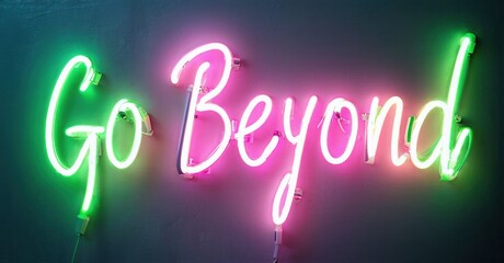 Bright neon sign displays words Go Beyond. Pink, green hues illuminate dark background. Inspiring message, modern aesthetic.