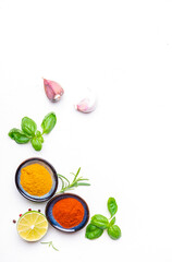 Food, cooking, spices background, ground chili pepper and turmeric, rosemary, garlic, lime, Indian and Asian cuisine ingredients, white copy space, top view
