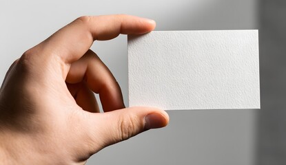 Fototapeta premium Hand holding blank business card isolated on white background