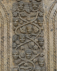 Column with figures of angels sculpted in stone.