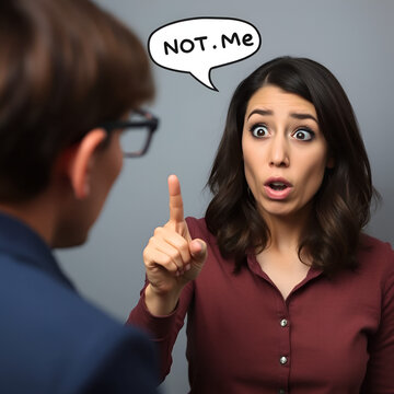 Baffled woman reacting to accusation with surprise, pointing finger to herself rejecting recrimination - waving finger "not me" body language