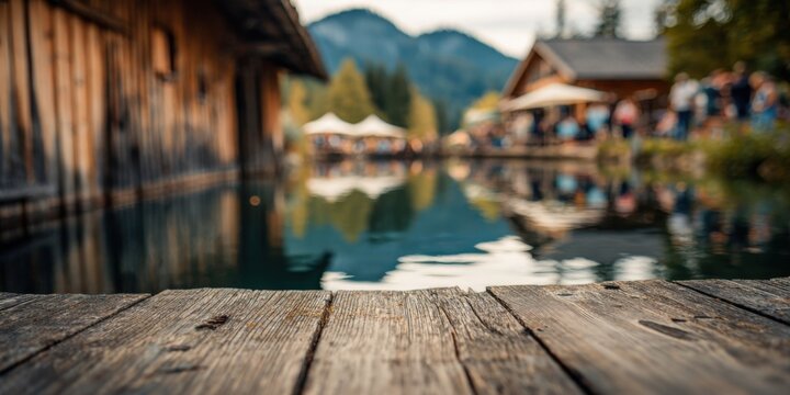 Scenic View of a Calm Lake with Wooden Piers and Rustic Cabins Surrounded by Lush Green Mountains in the Background