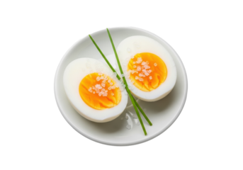 Close-up of two perfect hard-boiled egg halves with golden yolk, sea salt, and chives on a white plate, isolated on transparent, studio lighting, sharp focus, gourmet food presentation concept