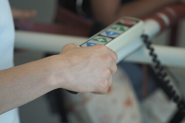 Control device held during a therapy session in a clinic