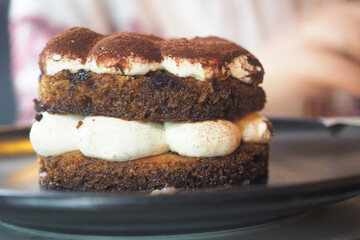 Delicious layer cake with creamy filling served on plate