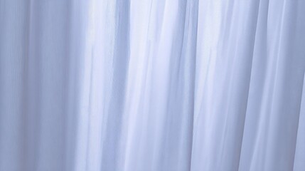Obraz premium Gentle sunlight streaming through sheer white curtains in a calming interior.