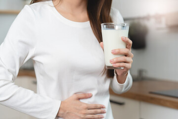 lactose intolerance concept. Woman having a stomach ache from lactose intolerance.