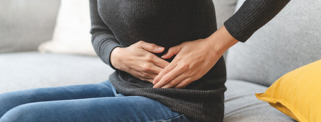 close up woman suffering stomach pain from food poisoning.