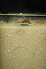 Refreshing iced beverage in glass with condensation
