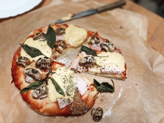 Freshly baked homemade halloween pizza with mushroom skulls baked in the oven. High quality photo