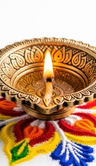 Close-up macro of decorated Diwali diya with glowing flame and rangoli.