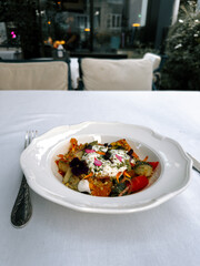 Colorful salad served at a classy restaurant during afternoon hours in an elegant setting