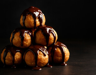 Stack of Profiteroles or Cream Puffs with Rich Chocolate Drizzle
