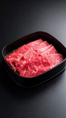 Raw beef slices in a black box