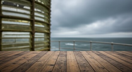 Mockup of wooden deck overlooking the ocean with a cloudy sky and a blurred structure on the left for commercial usage