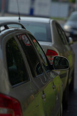 An artistic portrayal of parked cars with reflections, showcasing urban life and transportation...