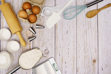 Homemade Dough Recipe (Eggs, flour, milk, sugar) and wooden kneading dough on a wooden table, view from above	
