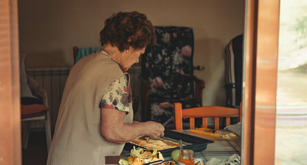 senior woman preparing a dessert or cake at home