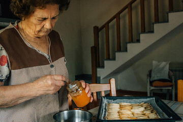 senior woman preparing a dessert or cake at home