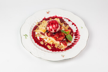 Close-up of a slice of strawberry pie served with a scoop of ice cream on a white background