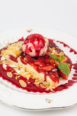 Strawberry tart dessert with ice cream and almond flakes