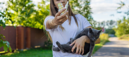 Woman holding a cat. Woman is allergic to cats. Allergy to cat fur.