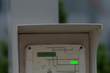 Close-up of a control panel featuring a green indicator light and a maze-like diagram, symbolizing operational status or system monitoring.