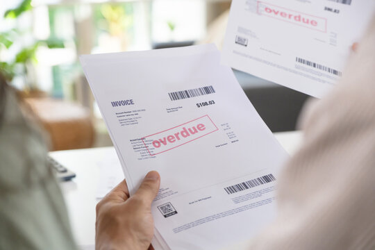 Couple facing overdue bills and financial pressure at home, stressed by inflation and economy recession