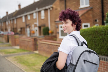 Teen age school girl going back to school wearing school uniform