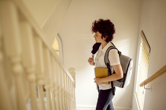 Teen age school girl with backpack going to school