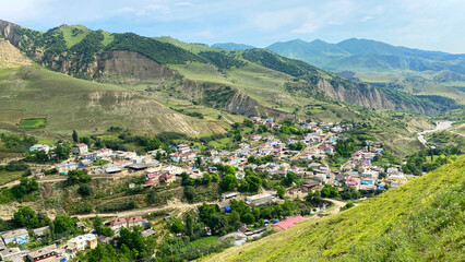 Aerial view of the mountain village of Kuzun in the amazing green valley of Azerbaijan. The small...
