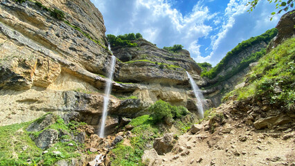 Stunning view of two unimaginably beautiful waterfalls in the village of Laza in Azerbaijan. A bizarre rocky mountain. A popular tourist destination