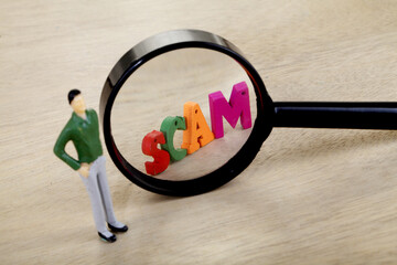 SCAM letters through magnifying glass