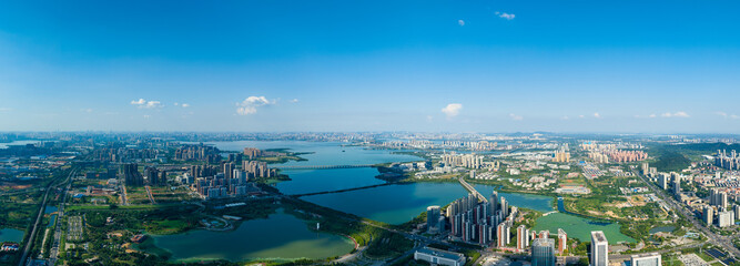 The expansive Jiangxia city unfolds around the serene Tangxun Lake in China, presenting a...