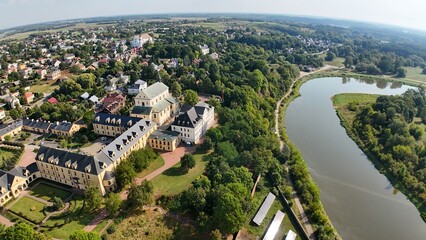 Aerial panoramic photo of photovoltaic panels on a hillside above a river in Drohiczyn