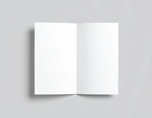 Fototapeta premium Blank folded paper mockup on gray background, top view of empty white sheet template for flyer, brochure, invitation, or leaflet design presentation, minimal clean stationery concept with soft shadows