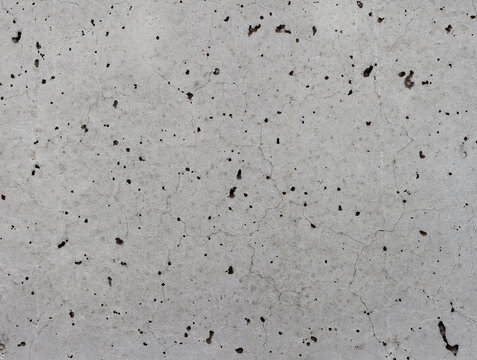 A raw, untreated exposed concrete surface with a slightly irregular texture.